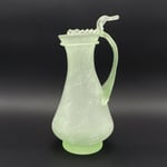 Kanne aus leicht gürnlichem Glas mit breitem Bandhenkel. Auf den Rand aufgelegtes, mit Pinzette herausgearbeitetes Wellenband.  4. Jh.n.Chr.  Fundort: Köln, St. Severin  Inv. Nr. N78,  Höhe ca 280 mm  Gefäß Nr. 203