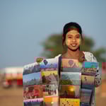 Young woman sells souvenirs to tourist doing a balloon ride, Myanmar © Stephan Stamm