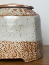 shino jar with hand-carved foot