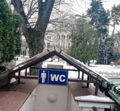 Public toilet with WC sign in front of Riga Opera House