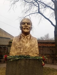 Gold coloured bust of Lenin in Riga garden