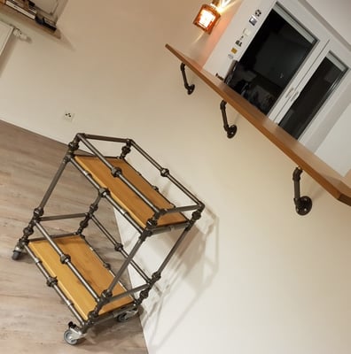 Servierwagen und Regalkonsolen. Die Bretter des Servierwagens sind mit 1-laschigen Rohrschellen aufgelegt. | (c) M. Schreiner