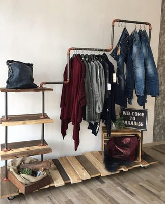 Abgestufte Kleiderstange aus Wasserrohr im Laden