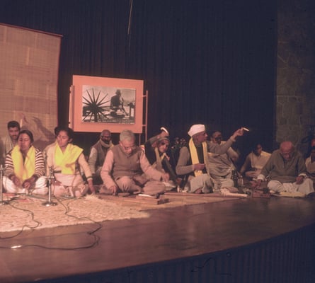 Prabhudas Gandhi (right) sitting on stage spinning during a khadi programme organized by Tara Gandhi Bhattacharjee, New Delhi, 1986.