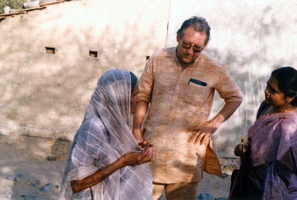 Peter Rühe and teacher Saroj Goda talking to a surviving victim after the Gujarat Earthquake, 2001