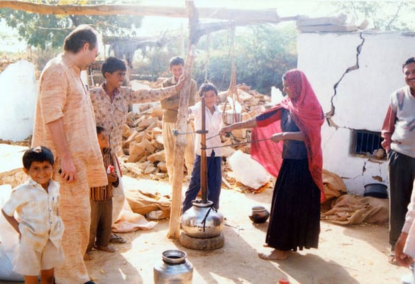 Peter Rühe observes a surviving women after the Gujarat Earthquake making butter amidst the debris, 2001