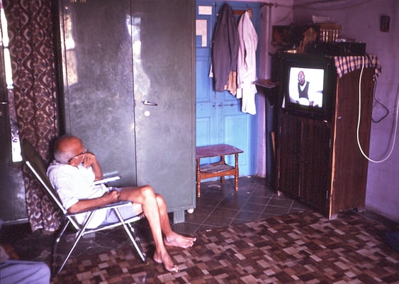 Prabhudas Gandhi watching his programme "Gandhi as a Journalist" in his home at Rashtriya Shala, Rajkot, 1990.
