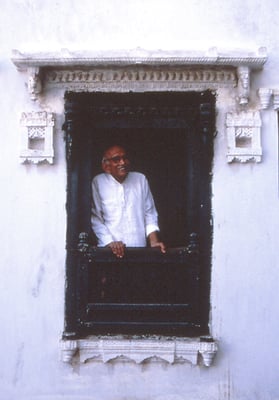 Prabhudas Gandhi looking through a window of a building at Porbandar, January 3, 1988.