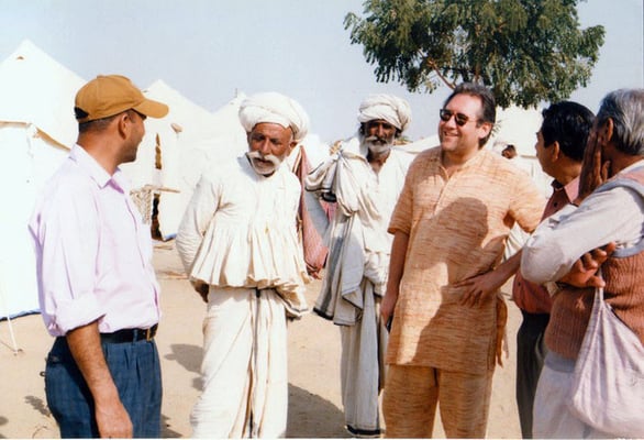 Peter Rühe talking with surviving men in traditional dresses after the Gujarat Earthquake, 2001