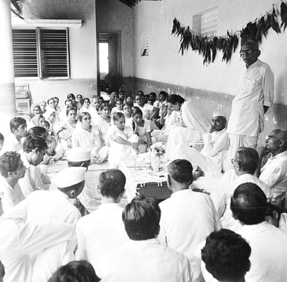 Prabhudas Gandhi delivering a lecture at Rashtriyashala, Rajkot, 1980. Next to him: his wife Amba and Purushottam Gandhi (left) and Kanu Gandhi (right).