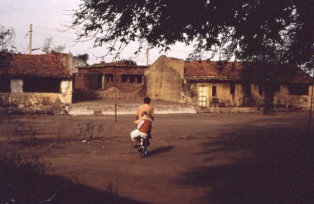 Prabhudas Gandhi riding on the back of a bicycle driven by Benjamin Pütter at Kasturba Ashram near Rajkot, January 2, 1988.