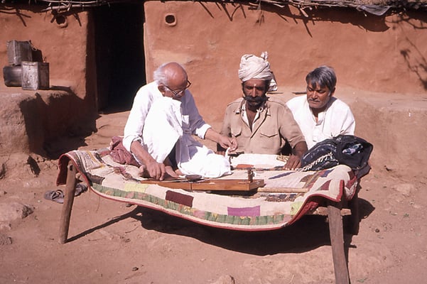 Prabhudas Gandhi demonstrates cotton spinning to village folks in the draught-effected Barda Hills near Porbandar, 1987.
