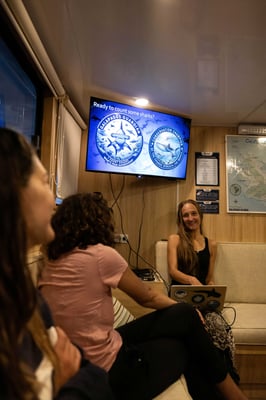 Jenny Green leads an educational talk aboard a Galapagos liveaboard about citizen science