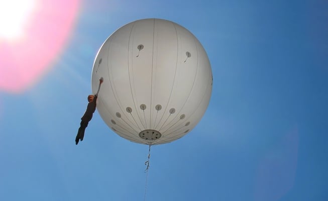 der Bubble Man ... eine lebensgroße Figur schwebt an einem Heliumballon über der Stadt
