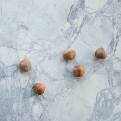 Hazelnuts on light grey marble countertop