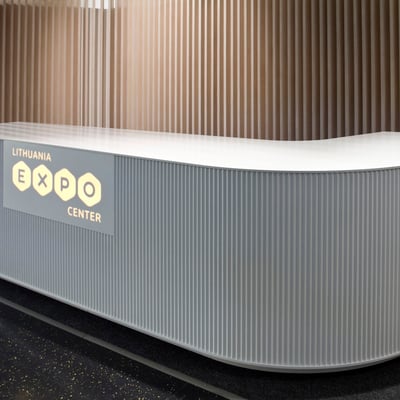 Reception desk in acrylic stone with moulded side and integrated logo panel, visible only when backlit / fabricator: Gforma