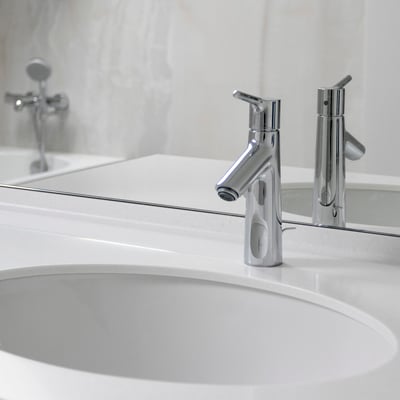 Bathroom vanity from Corian Glacier White solid surface with a small splashguard and integrated porcelain sink / fabricator: Gforma