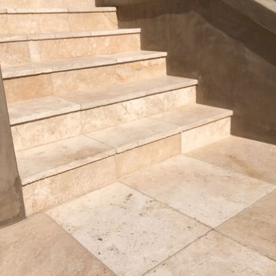Garden stairs clad in travertine tiles
