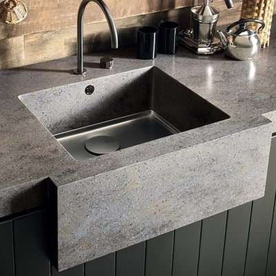 A solid surface sink from Corian with an integrated stainless steel bottom.