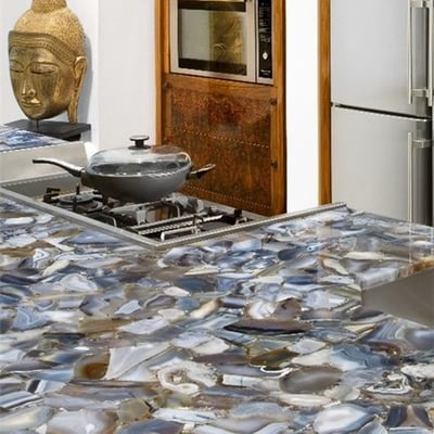 Kitchen island covered with exotic gemstone slab