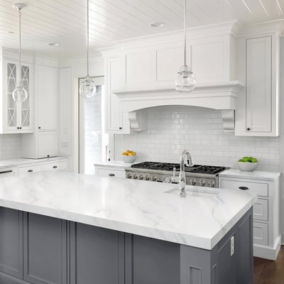 Kitchen island topped with white marble countertop