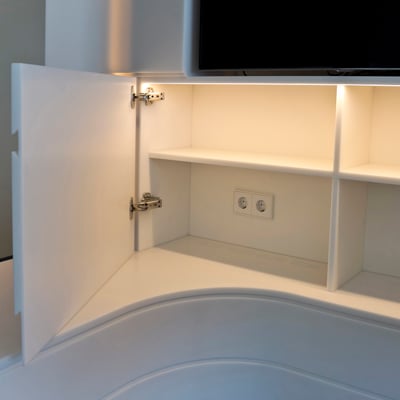 TV wall with cabinets fabricated from acrylic solid surface / fabricator - Gforma