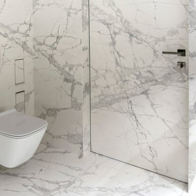 Bathroom floor from white porcelain tiles with grey veins