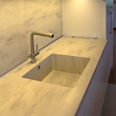 Solid surface worktop with integrated sink, and sliding splashwall with hidden cupbords / fabricator: Gforma