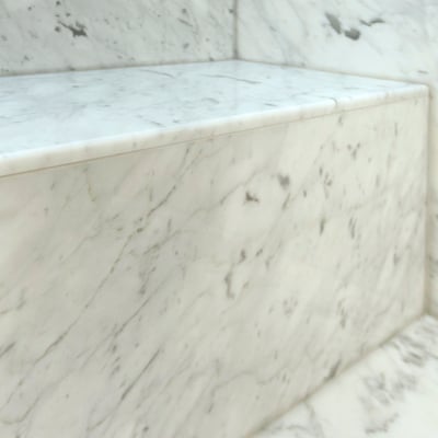 White marble shower bench and walls