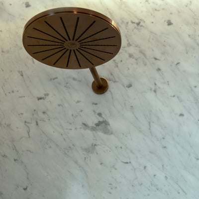 Shower wall from white marble with narrow grey veins