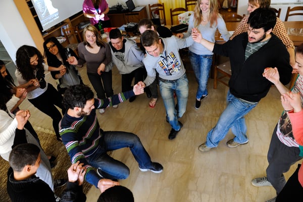 Greeks teaching other participants Greek traditional dances
