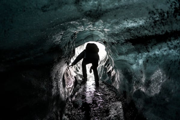 Iceland. A tourist emerges from the ice cave during a trip to the Katla volcano.