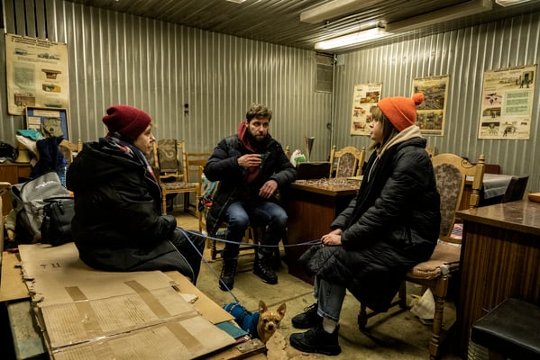 Oksana, Ostap and Daria inside the bunker as they wait for the air raid alarm to go off. 