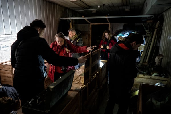 tourists as they explore what's inside the crates, full of relics from the Soviet era
