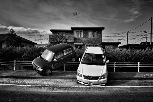 abandoned cars parked by the tsunami, Odaka city, Fukushima "No-Go Zone", Japan.