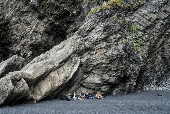 Iceland. Tourists rest after a trip on the black beach in Reynisfjara, one of the country’s main attractions.