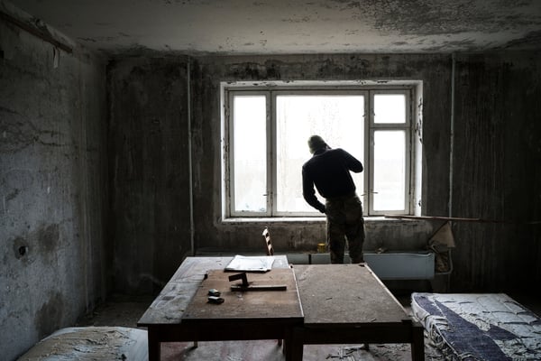Jimmy checking from the window in his apartment in Pripyat if police is around before leaving