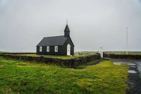 Iceland. The Black Church in Búdir, considered a national monument and situated in the middle of a lava field. It was built by Bent Lárusson in 1703.