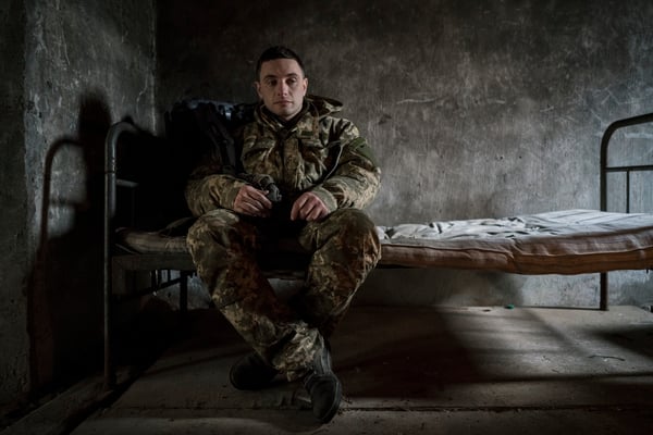 Maxim resting exhausted in the abandoned pig-shed after a 20 km march in the woods