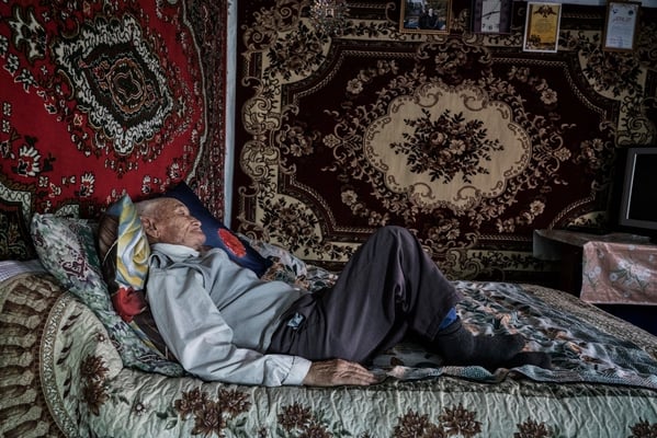 Naurizbek Umarov 85 years old lies on his bed in his home in the contaminated village of Bodene. He is a witness of the atomic explosions and lives in the contaminated village of Bodene situated close to the border of the Polygon.