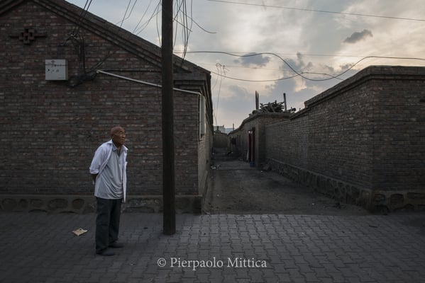 a miner enjoying the peace of his retirement in the semi-evacuated town of Gongwusu