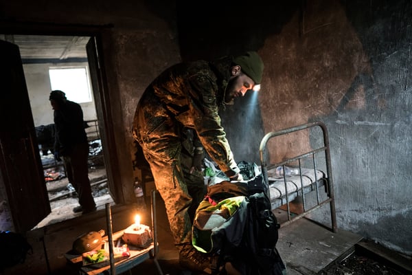 Jimmy preparing for the night in an old pig-shed. This abandoned building is another stop along the way to Pripyat, 45 km from the border of the Zone of exclusion and 15 from Pripyat