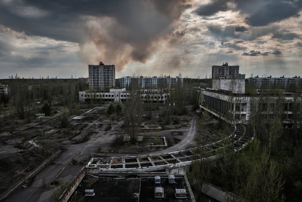 The forest burns behind the ghost city of Pripyat. One of the greatest dangers existing in the exclusion zone are fires. Fire burns trees raising radioactive ash that is spread in the air, causing a new nuclear fallout.