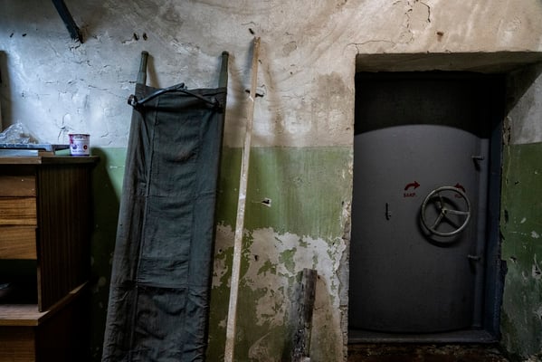 entrance to the bunker with a rescue stretcher from the soviet time and a nuclear blast door.