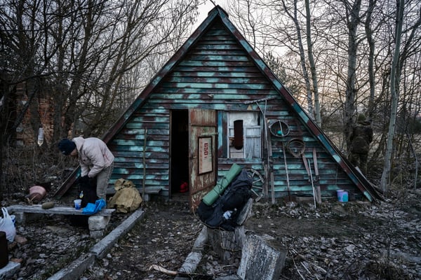 Sasha in front of the foresters cabin while preparing his backpack before heading to Pripyat