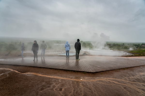 Iceland. Tourists visit the Geysir geothermal complex. Geysir, known also as the Great Geysir, is a geyser situated in the Haukadalur valley.