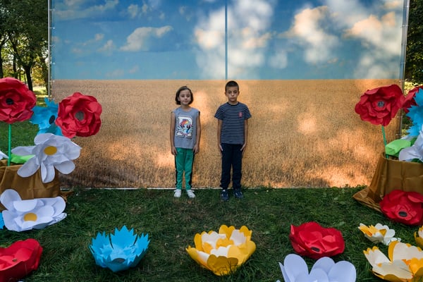 Children while taking a souvenir photo in front of the Ukrainian flag during the local Ivankiv fair. Ivankiv.