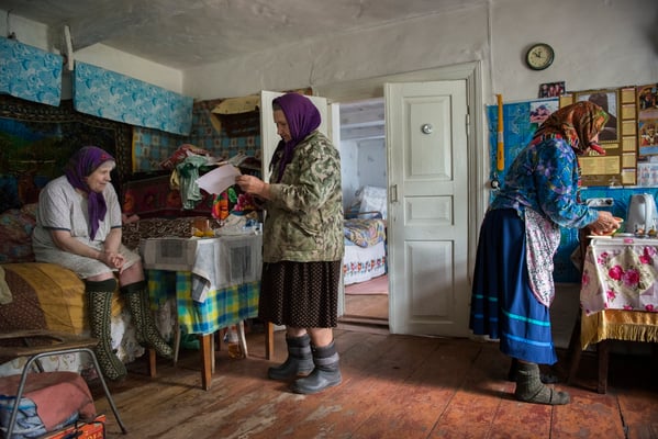 Hanna with Maria and her sister Sofia in her house preparing the mushrooms for lunch, Kupovate village. Chernobyl Exclusion Zone.