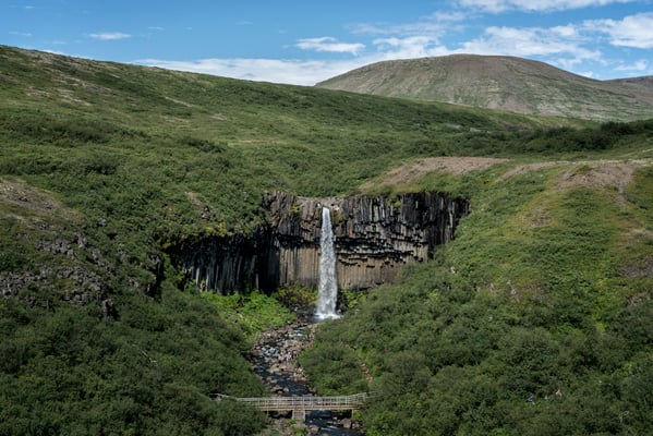 Iceland. The Svartifoss waterfall, also known as the Black Waterfall, is approximately 20 metres high and owes its name to the black basalt columns situated behind it. Svartifoss is located in the Skaftafell national park