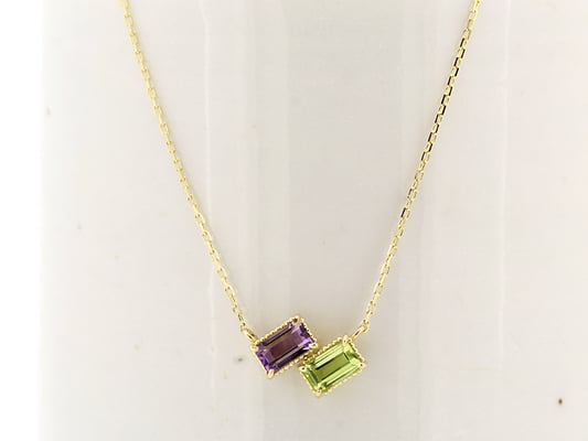 アメジストとペリドットのペンダント。イエローゴールドを合わせて、華やかな仕上がりに。